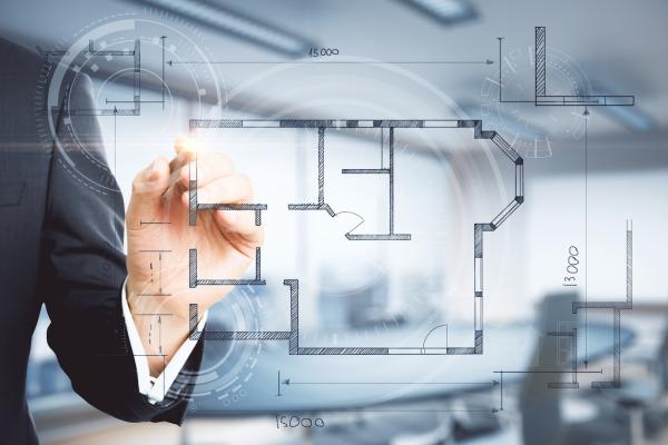 Kreativer Bauplan von Hand auf verschwommenem Innenhintergrund. Immobilien und Ingenieurwesen