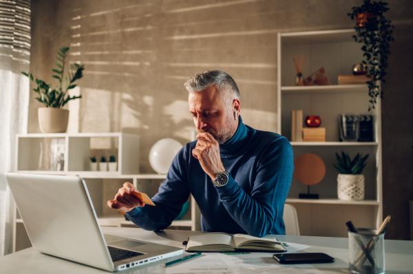 middle aged man online shopping with laptop and a 2023 02 14 20 27 23 utc